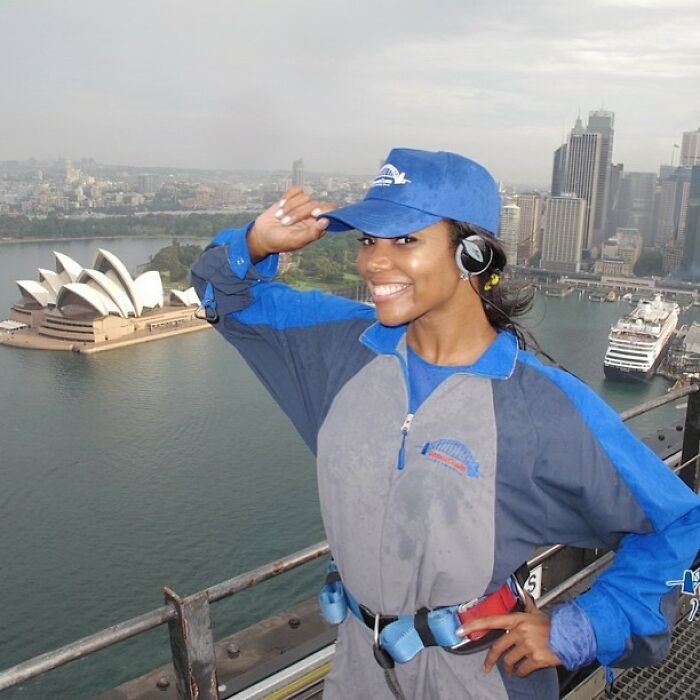 Smiling woman in blue gear posing for a photo with Sydney Opera House and city skyline in the background, Instagram posts.