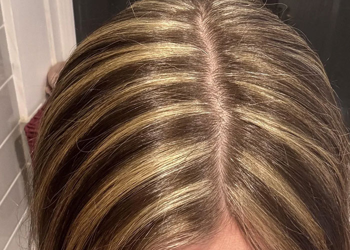 Close-up of hair with chunky highlights, showcasing a popular dumbest fad hairstyle from past decades.