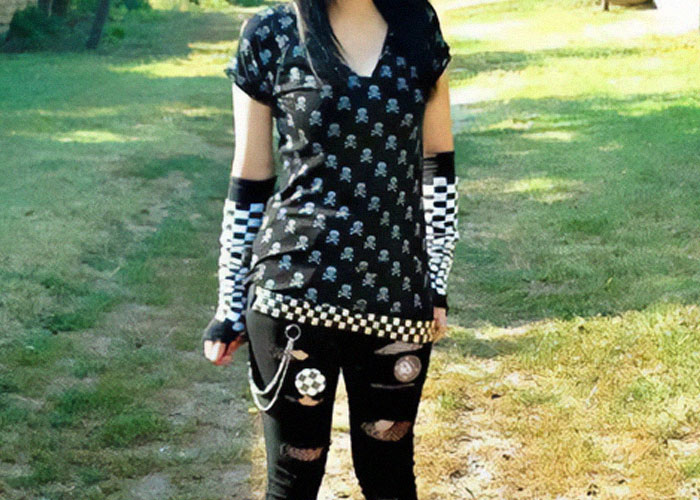 Teen dressed in an edgy punk outfit with checkerboard gloves and torn pants reflecting fashion fads participated in.