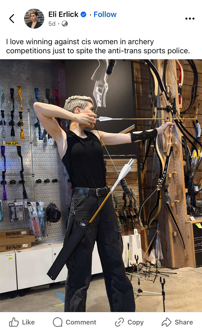 Trans archer practicing with bow and arrow indoors, highlighting winning against cis women in archery competitions.