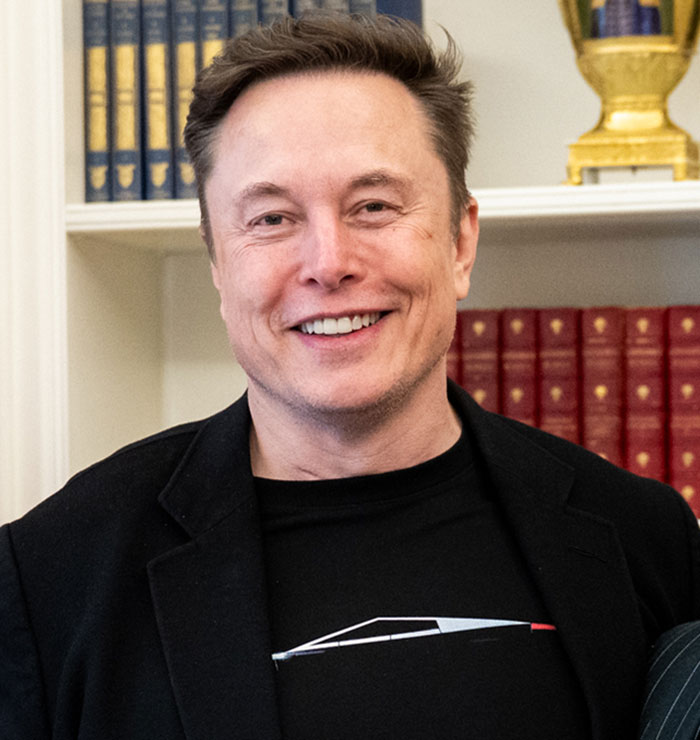 Elon Musk smiling indoors with bookshelves in the background, linked to discussions about Amber Heard's twins and embryo dispute. Elon Musk smiling indoors with bookshelves in the background, linked to discussions about Amber Heard's twins and embryo dispute.