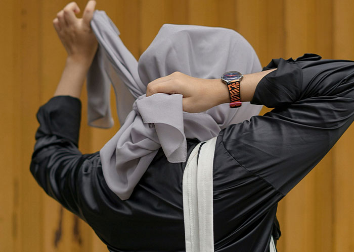 Parent covering face with cloth, showing embarrassment in public, reflecting worst kids behavior making parents want to disappear.