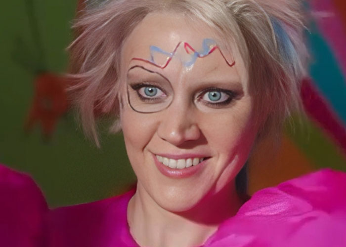 Smiling woman with colorful face paint and bright costume, illustrating parents sharing worst kids behavior in public moments.