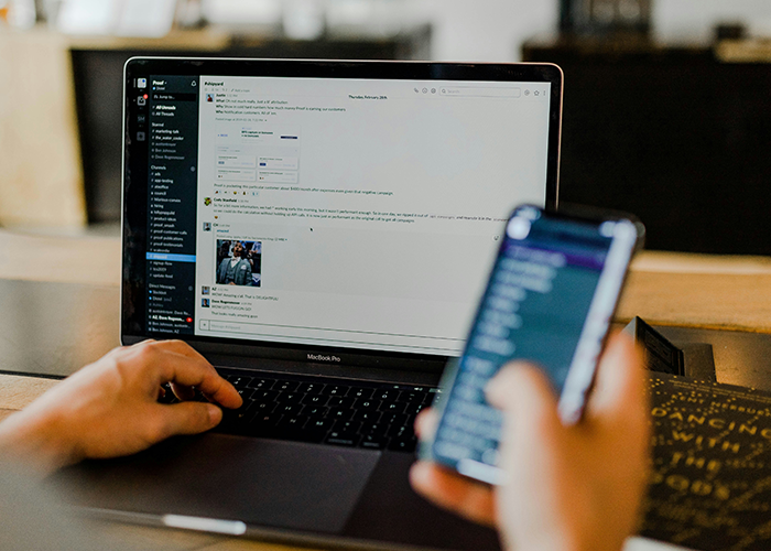 Engineer working on laptop and using smartphone, illustrating finger-snapping Karen treating engineer like a servant scenario.