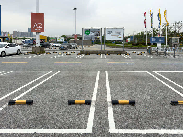 Empty parking lot with marked spaces near IKEA, illustrating a common scene in parking spot saving disputes.