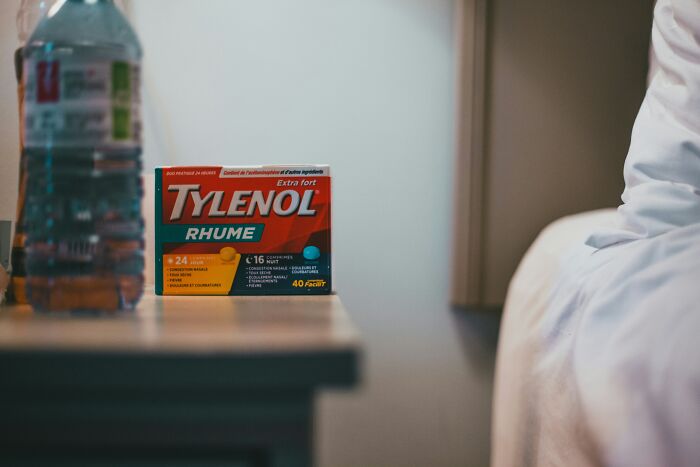 Box of Tylenol on a bedside table representing placebo effect examples in real life including medication and remedies.