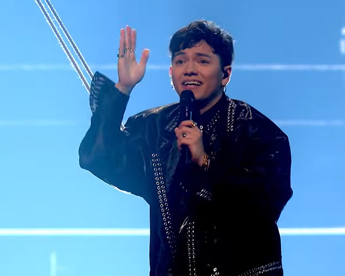 Austrian singer performing on stage during Eurovision 2025, showcasing a stunning and emotional moment.