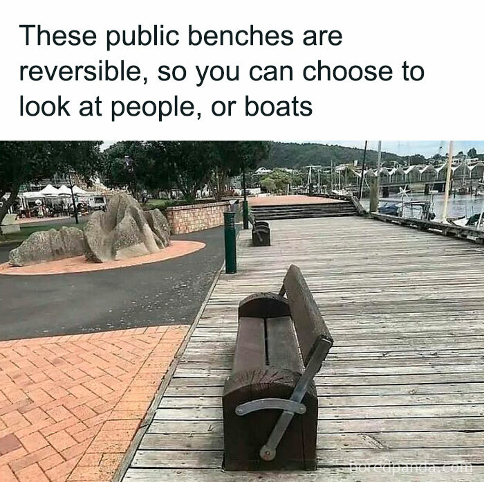 Public reversible benches on a wooden dock allowing people to choose view of people or boats near the water.