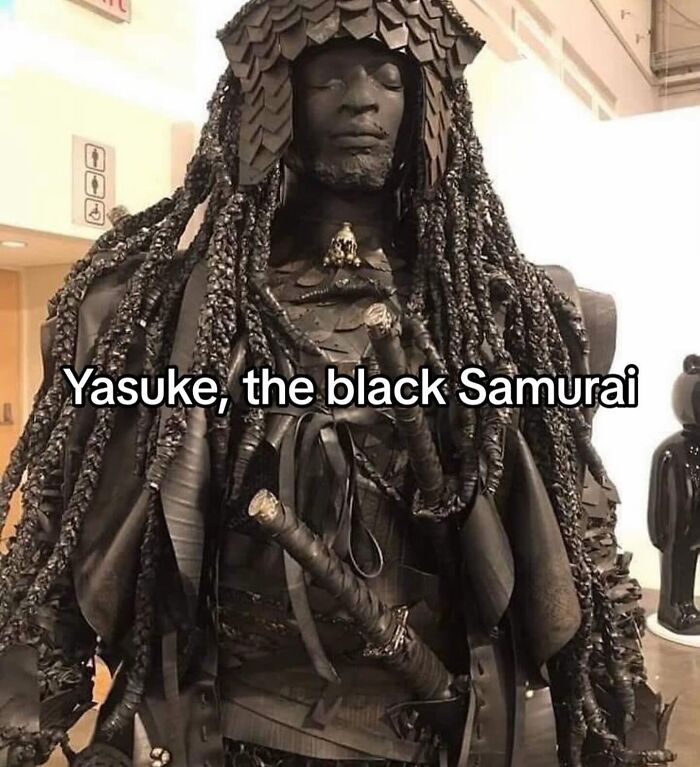 Statue of Yasuke the black Samurai with intricate armor and braided hair, showcasing unique craftsmanship and history.