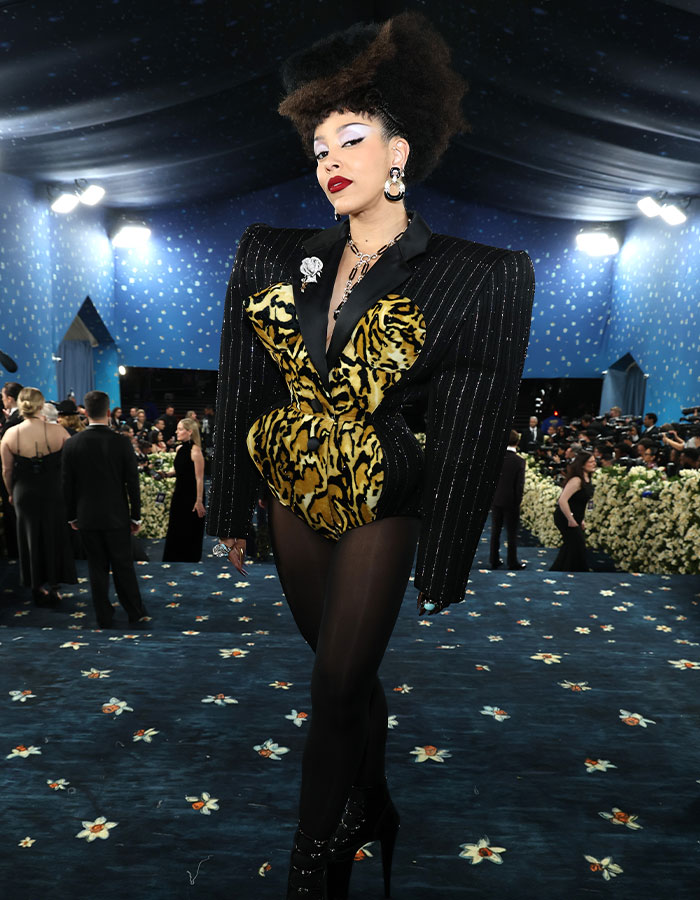 Person wearing a bold animal print and oversized structured jacket posing on the carpet at Met Gala fashion fails 2025 event.