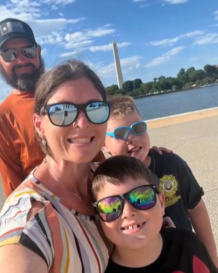 Family smiling by the water with the Washington Monument in the background before boating tragedy and remains found months later.