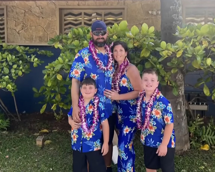 Family dressed in matching floral outfits and leis, symbolizing the remains of missing family found after boating tragedy.