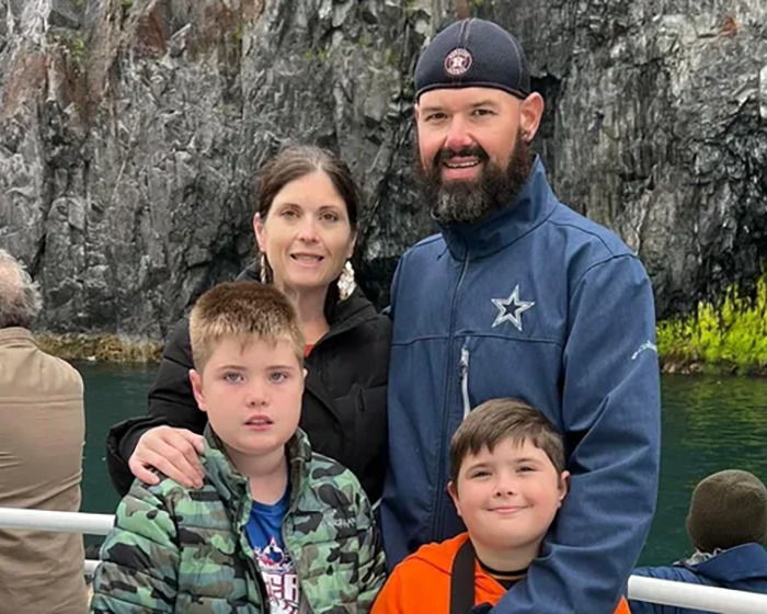 Family pictured near rocky shoreline, related to remains of missing family found months after devastating boating tragedy.
