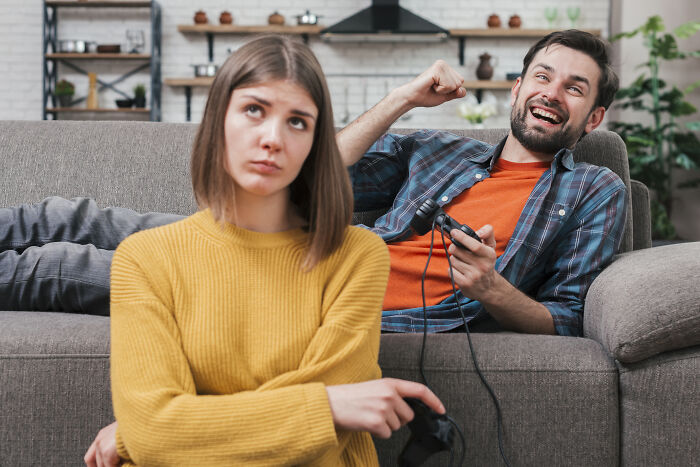 Man and woman playing video games, highlighting lost friendships and ultimatums involving male and female friends.