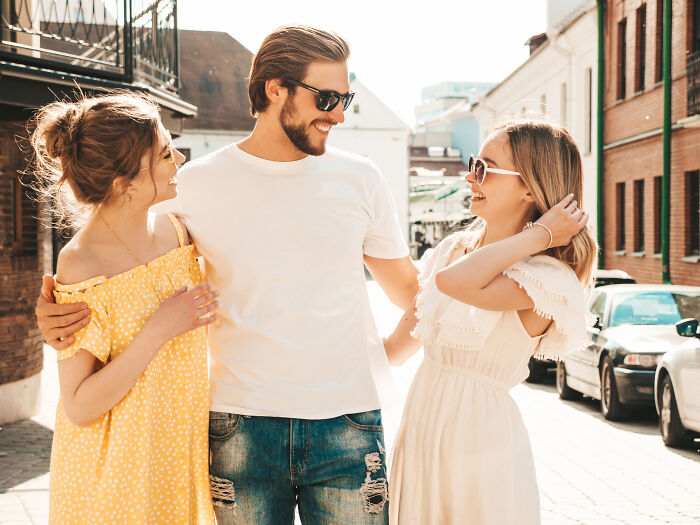 Man spending time with two female friends outdoors, illustrating tales of ultimatums and lost friendships.