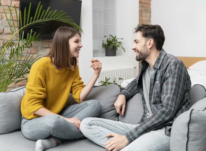 Man and woman having a friendly conversation on a couch, illustrating lost friendships and ultimatums between friends.