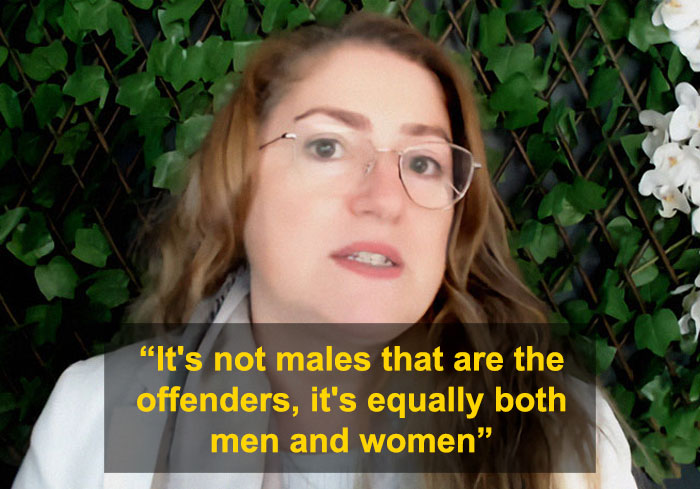 University professor discussing domestic violence claims that women commit violence as much as men in a debate setting.