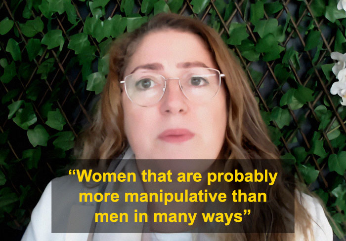 University professor with glasses discusses women and men domestic violence, addressing manipulative behaviors in a bold debate.