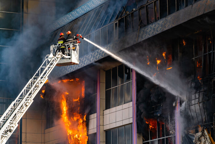 Firefighters battling intense flames at a burning building, illustrating dramatic final moments linked to chilling final words