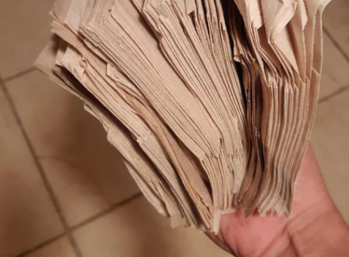 Stack of worn paper napkins held in hand, illustrating funny Americans recall moments shared by foreigners about the United States