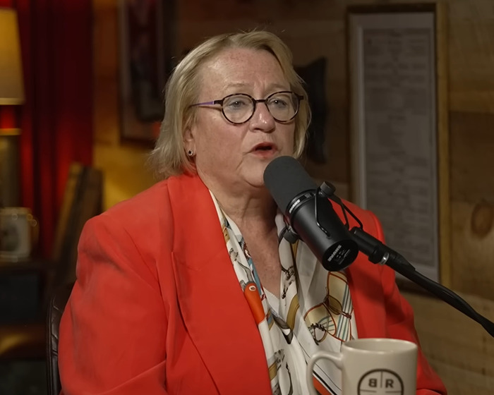 Former official in a red jacket speaking into a microphone about a $21 trillion underground city for the rich and powerful. Former official in a red jacket speaking into a microphone about a $21 trillion underground city for the rich and powerful.