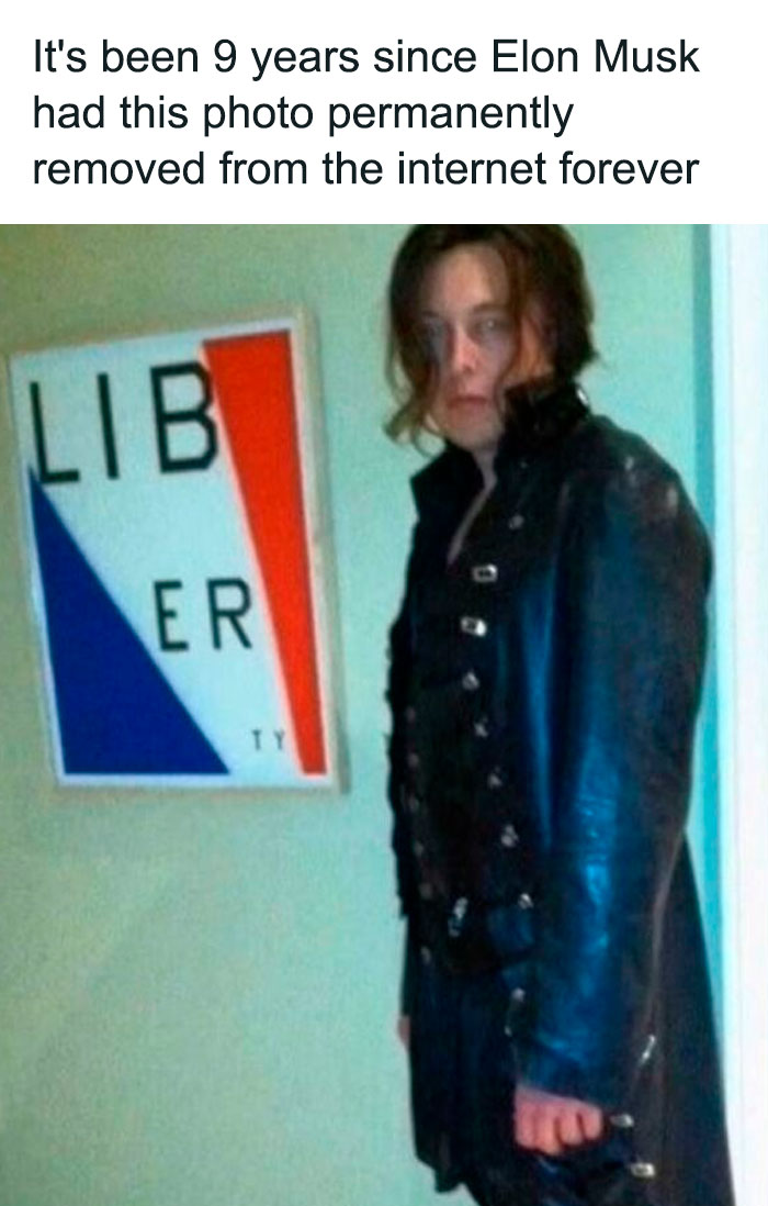 Person in dark gothic clothing standing next to a distorted liberty sign in a blursed image that may confuse the brain.