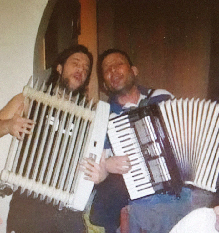 Two men holding unusual musical instruments in a weird pics or it didn’t happen moment from a Facebook group.