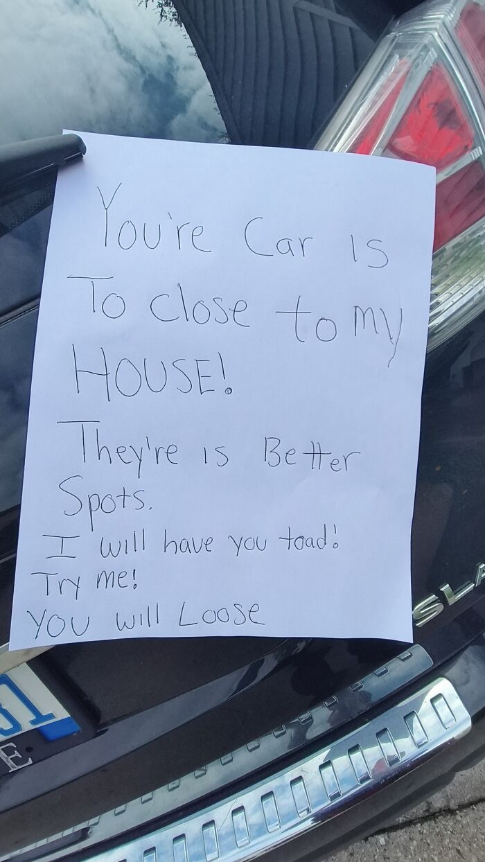 Note with misspelled words on the back of a black car warning about parking too close to the house weird pics or it didn’t happen moments