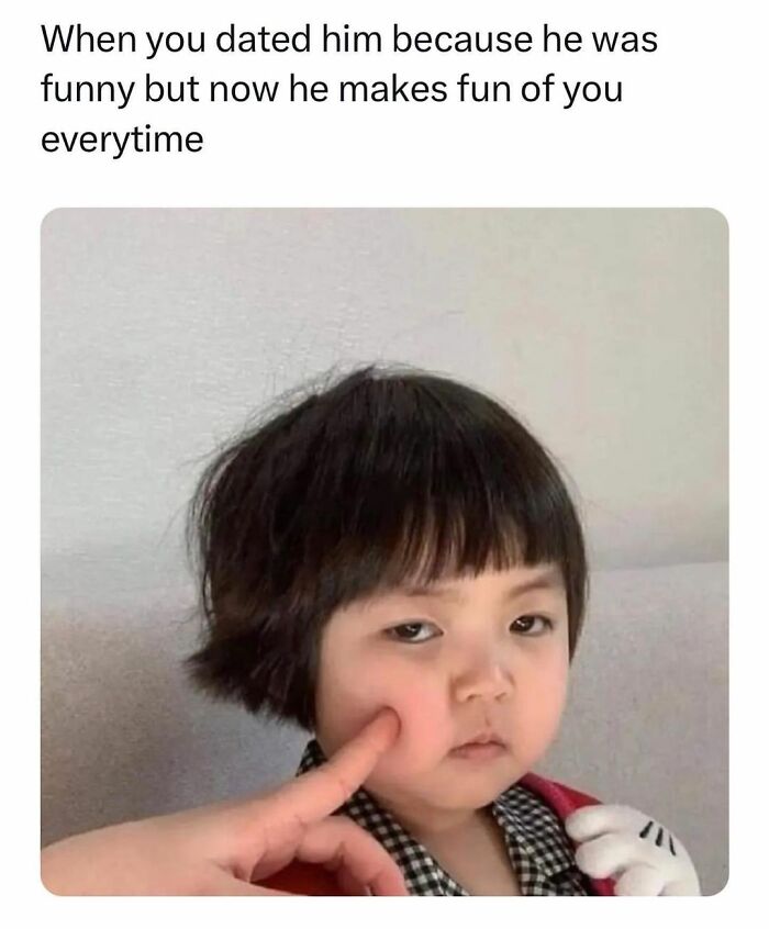 Child with a serious expression having cheek poked, illustrating a funny moment for daily serotonin boost from Instagram pics.