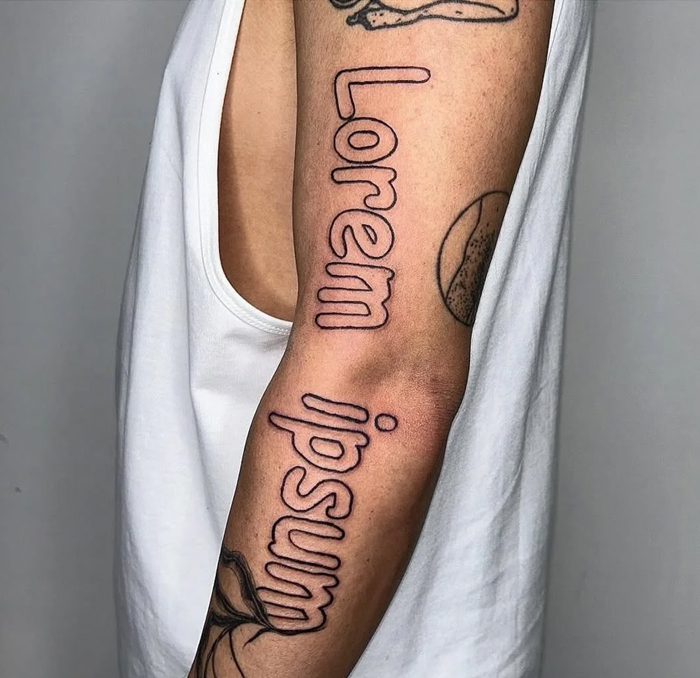 Arm tattoo with the words lorem ipsum in simple outline style, showcasing funny and interesting bad tattoos.