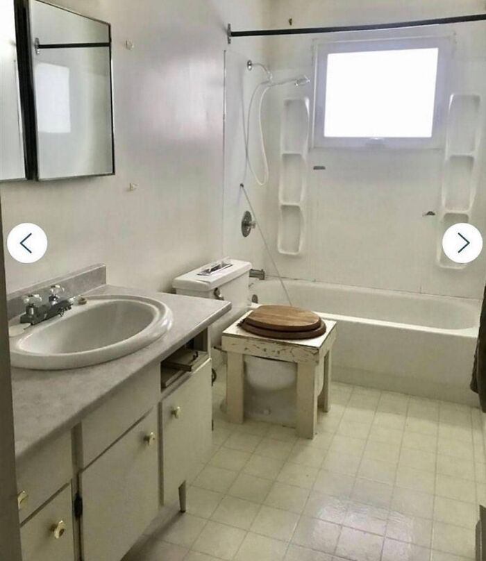 Small bathroom with unusual toilet setup featuring a wooden seat on a square platform, worst real estate photos ever.
