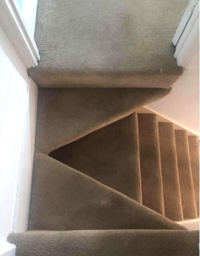 Carpeted stairs with an unsafe and confusing design, an example of worst real estate photos and home layouts.