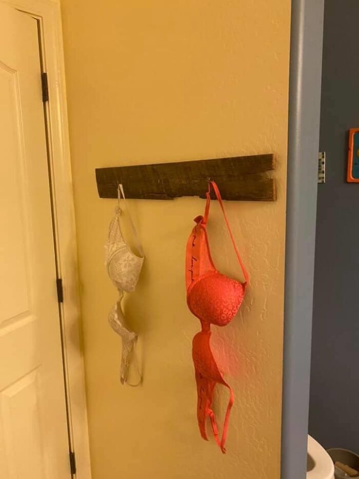 Bras hanging on a wooden rack in a home interior, an example of worst real estate photos ever seen.