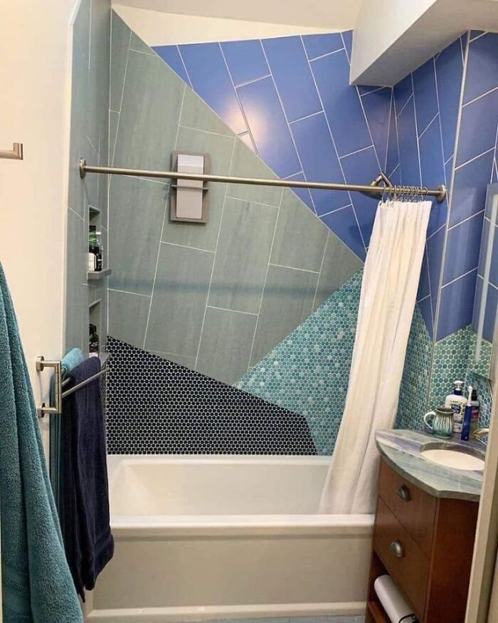 Bathroom with mismatched and oddly angled blue and green tiles illustrating worst real estate photos ever in home listings.