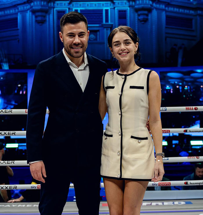 Man and woman standing in a boxing ring, smiling, with focus on pro boxer Georgia O&rsquo;Connor&rsquo;s appearance.