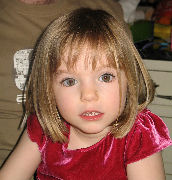 Young girl with light brown hair and green eyes wearing a red velvet dress, related to Madeleine McCann police request news.