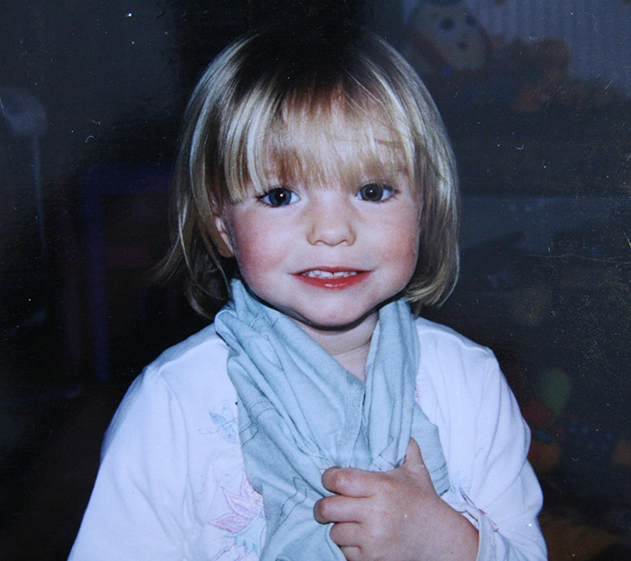 Young blonde girl smiling and holding a blue cloth, related to Madeleine McCann German police urgent request news.