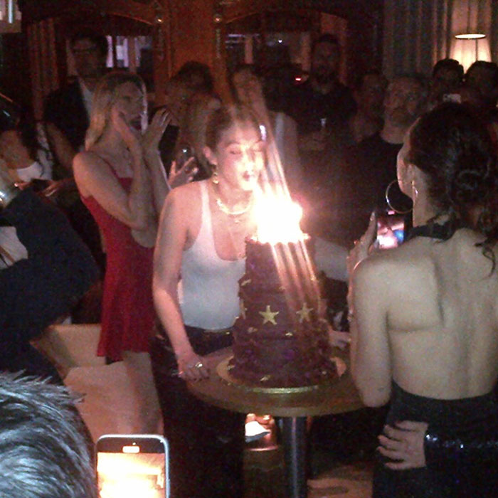 Gigi Hadid celebrating with a cake surrounded by friends as fans react to major age gap with Bradley Cooper. Gigi Hadid celebrating with a cake surrounded by friends as fans react to major age gap with Bradley Cooper.