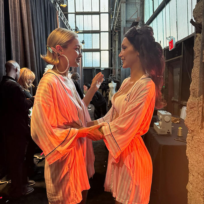 Gigi and Bella Hadid sharing a moment backstage wearing matching robes, revealing their secret sister story. Gigi and Bella Hadid sharing a moment backstage wearing matching robes, revealing their secret sister story.