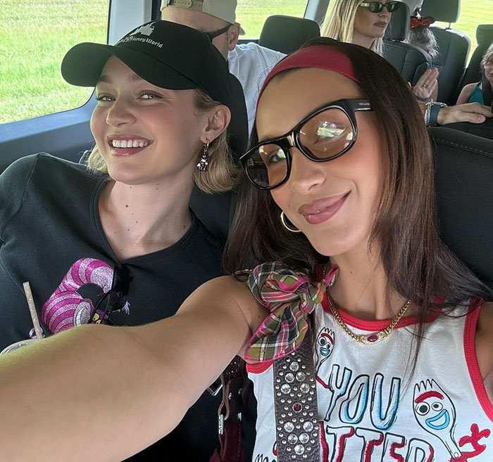 Gigi and Bella Hadid smiling together inside a vehicle, revealing news about a secret sister from their father's past. Gigi and Bella Hadid smiling together inside a vehicle, revealing news about a secret sister from their father's past.