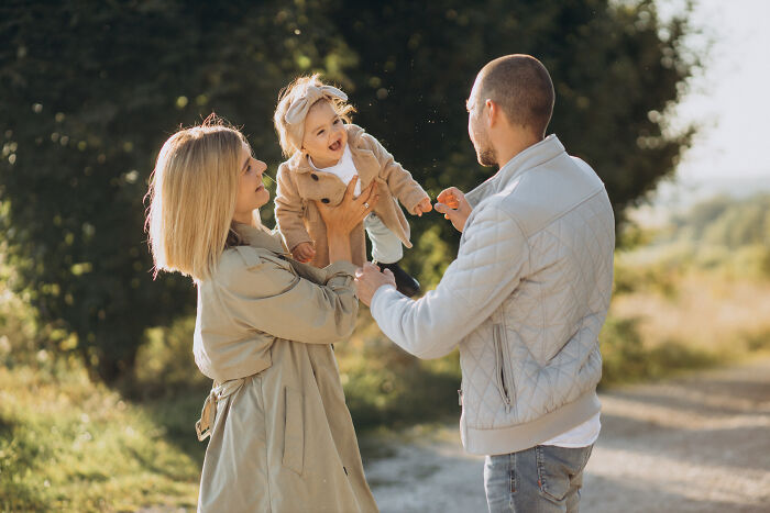 Young couple with their baby outdoors, portraying moments after men ruined things with their partners and life changed.