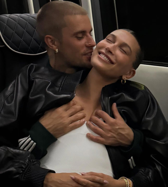 Justin Bieber affectionately holding wife Hailey&rsquo;s chest while they smile in a candid, intimate moment inside a vehicle