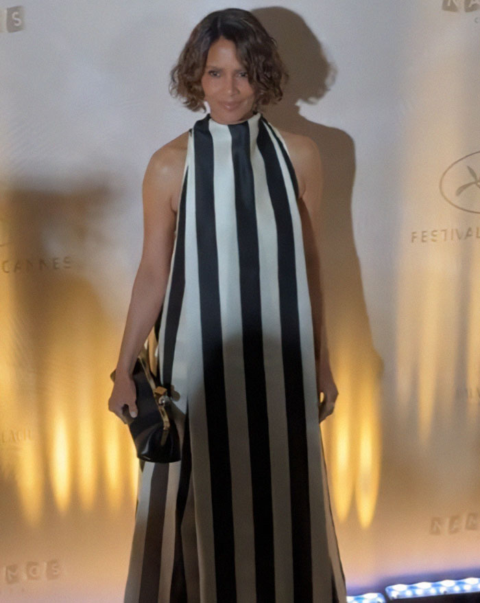 Halle Berry wearing a black and white striped dress at Cannes, affected by the festival's new dress code rules. Halle Berry wearing a black and white striped dress at Cannes, affected by the festival's new dress code rules.
