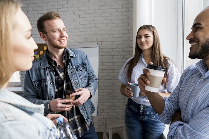 Group of young adults having a casual conversation indoors, highlighting childhood habits and attention-seeking behaviors as red flags.