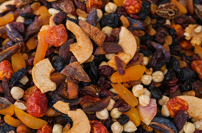 Close-up of assorted dried fruits and nuts, highlighting healthy foods dentists and doctors suggest avoiding.