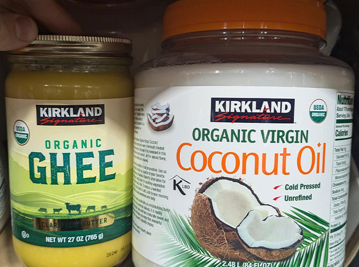 Jar of organic ghee and jar of organic virgin coconut oil highlighting healthy foods to skip according to dentists and doctors.