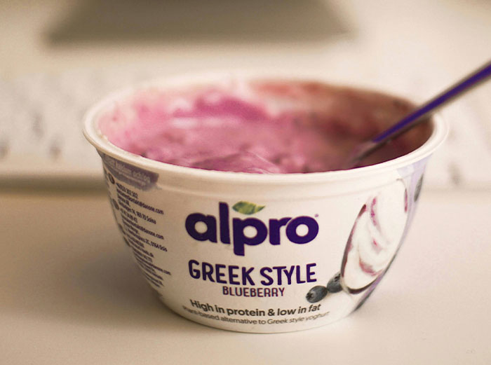 Container of blueberry Greek style yogurt, an example of healthy foods dentists and doctors might advise skipping.