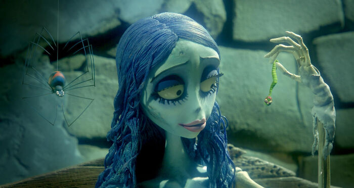 Animated character with blue hair holding a small creature, illustrating unconventional crushes concept in a whimsical style.