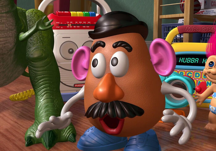 Toy Mr. Potato Head and green toy dinosaur in a colorful playroom illustrating unconventional crushes people have.