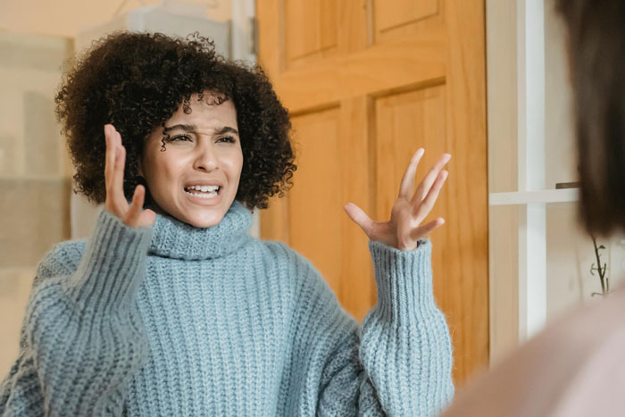 Woman expressing frustration during a heated conversation with sister about past debt and refusing to help. Woman expressing frustration during a heated conversation with sister about past debt and refusing to help.